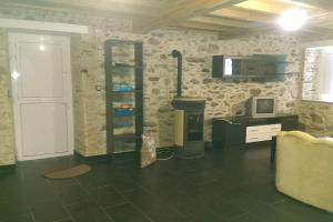 a living room with a fireplace and a tv at Casa Rural Ortigueira in A Coruña