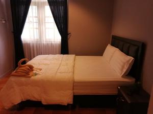 a bedroom with a large bed with a window at airport house in Bangkok