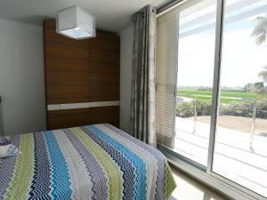 a bedroom with a bed and a large window at Holiday Home Xaloc by Interhome in L'Ampolla