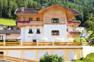 a building with umbrellas in front of it at Pension Mariandl in Neustift im Stubaital