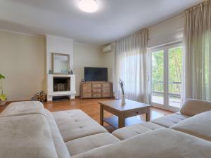 a living room with a couch and a tv at Holiday Home Villa Toni by Interhome in Umag +44 photos