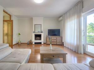 a living room with a couch and a table at Holiday Home Villa Toni by Interhome in Umag