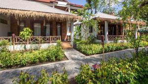 a house with a garden in front of it at La Rivière d' Angkor Resort in Siem Reap