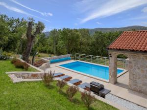 a swimming pool in a yard with a gazebo at Holiday Home Villa Matija by Interhome in Drivenik