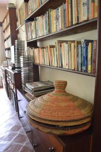 
a book shelf filled with books on top of each other at The Researchers Rest in Arusha
