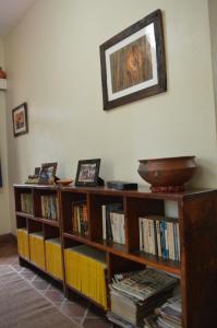 
a living room filled with lots of books and pictures at The Researchers Rest in Arusha
