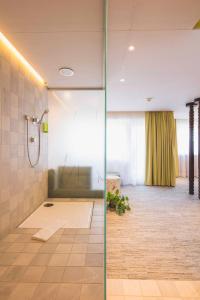 a bathroom with a shower with a glass door at Hotel Luise in Erlangen