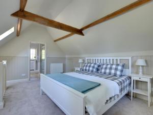 a bedroom with a large white bed in a room at Holiday Home Valley View by Interhome in Weald
