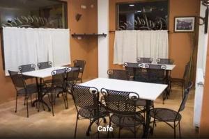 a group of tables and chairs in a room at Hostal Calderon Cuenca in Cuenca +22 photos