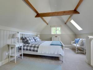a bedroom with a bed and a table and a chair at Holiday Home Valley View by Interhome in Weald
