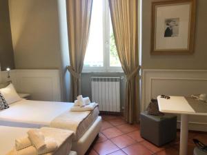 a hotel room with two beds and a window at 207 Inn in Rome