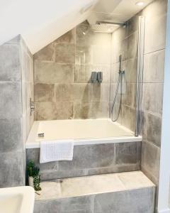 a bathroom with a shower and a bath tub at Bridgnorth B&B in Bridgnorth