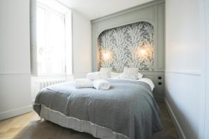 A bed or beds in a room at Maison Paul & Romy- L'horloge