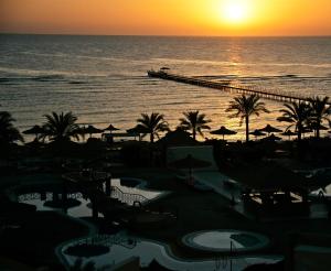 uma vista para o oceano e um cais ao pôr-do-sol em Flamenco Beach & Resort Quseir em Quseir