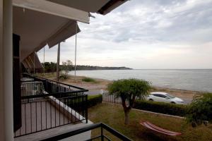 a view of the ocean from the balcony of a house at Mini studio apt. in Epanomi