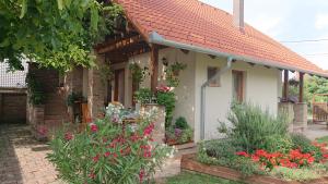 una pequeña casa con flores delante en Ágnes Apartman, en Kaposvár