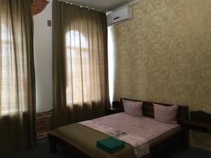 a bedroom with a bed and a window with curtains at Moskovs'kyi Avenue 41 in Kharkiv