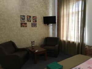 a living room with two chairs and a table at Moskovs'kyi Avenue 41 in Kharkiv