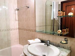 a bathroom with a sink and a toilet and a shower at Golden View by Homie in Funchal