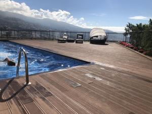 a swimming pool on a deck with a view of the water at Villa Beausoleil by Madeira Sun Travel in Funchal