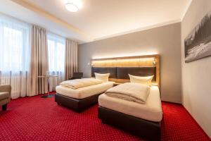 Postel nebo postele na pokoji v ubytování Hotel Vollmann