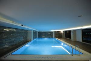 a large swimming pool in a building with at Heybeli Garden in Bursa