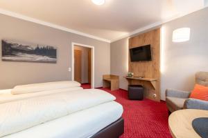 Postel nebo postele na pokoji v ubytování Hotel Vollmann