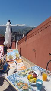a table with a plate of fruit on a balcony at La Porta dell'Alcantara in Gaggi