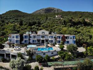 an aerial view of a house with a mountain in the background at Dolphin Apartments 1 in Parga