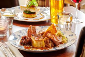 two plates of food on a table with drinks at The Jug And Bottle in Heswall