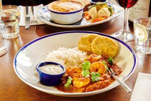 two plates of food on a table with rice at The Jug And Bottle in Heswall