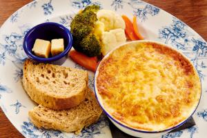 a plate of food with bread and cheese and broccoli at The Jug And Bottle in Heswall