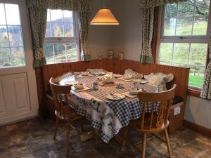 a dining room table with a table cloth on it at Castle Peroch in Dunkeld