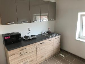 a kitchen with a sink and a counter top at 3-Bedroom apartment in Rajhrad, with kitchen, 2 bathrooms, parking in Rajhrad