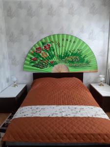 a bedroom with a bed with a painting on the wall at Малко oазисче in Sofia