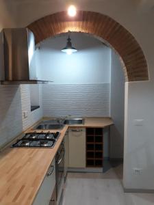 a kitchen with a sink and a stove top oven at L' Antico Comune in Cavriglia