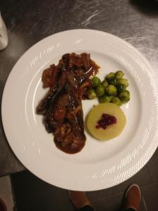 um prato de alimentos com carne e legumes sobre ele em B&B Restaurant Le Pernollet em Evionnaz