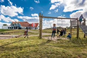 a group of people playing on a swing at Stayokay Hostel Terschelling in West-Terschelling
