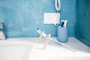 a pair of toothbrushes sitting on a bathroom sink at White Asses Rooms in Castellammare del Golfo +52 photos