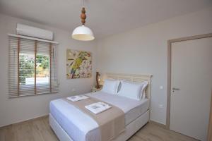 Ένα ή περισσότερα κρεβάτια σε δωμάτιο στο Aegean Suites