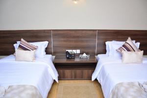 Razana Hotel客房内的一张或多张床位