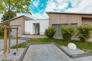 a house with a courtyard with a building at MotelplusHotel BiggeSeeFront in Olpe