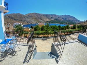 a patio with a view of the water and mountains at Irene Double Apartment Katoi in Symi