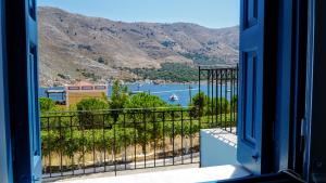 an open door with a view of a body of water at Irene Double Apartment Katoi in Symi