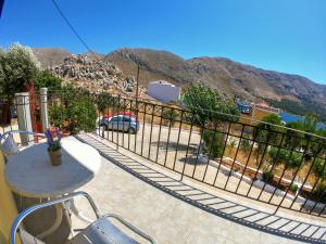 a balcony with a table and a view of a parking lot at Irene Double Apartment Katoi in Symi