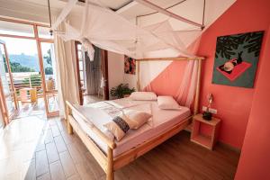 a bedroom with a bed in a room with red walls at OMX Hotel Kimi in Kigali