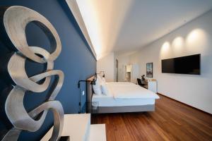 1 dormitorio con cama y pared azul en MotelplusHotel BiggeSeeFront en Olpe