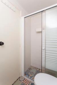 a shower with a glass door in a bathroom at SUPERNOVA - Hostel & Café in Porto