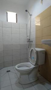 a bathroom with a toilet with the seat up at Calamba Pension Plaza in Calamba