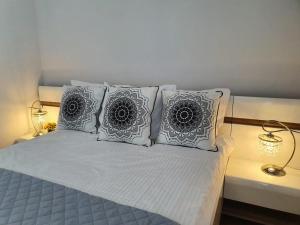 un letto con 4 cuscini e 2 lampade di Sailor- Z WIDOKIEM NA MORZE- 365PAM a Ustronie Morskie